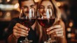 © andi - Couple toasting with red wine