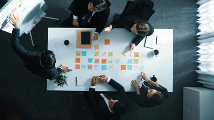 Poster - Top down aerial view of professional businessman find solution while brainstorm idea with executive manager by using sticky notes. Group of diverse start team share marketing strategy. Directorate.
