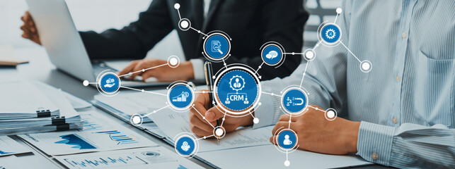 Poster - Business professionals collaborate in a modern office, using digital CRM solutions to analyze data and enhance client management for improved productivity and strategic growth. Amity