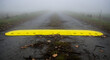 © TITI - Yellow Speed Bump In Foggy Landscape Along A Rural Roadway Environment