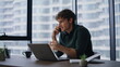 © stockbusters - Worried executive talking cellphone discussing document mistake in modern office