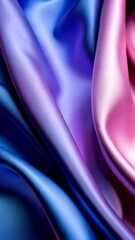 Poster - Elegant folds of shimmering fabric with a gradient of blue, purple, and pink creating a smooth, flowing, abstract background.