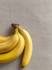 Poster - Ripe Bananas Arranged on Linen Fabric With a Neutral Palette Inviting Natural Simplicity and Warmth in Everyday Life