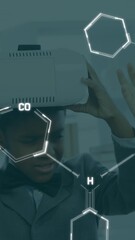 Poster - Animation of chemical formulas over african american boy using vr headset
