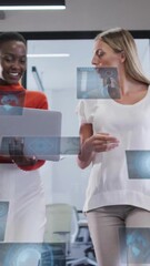 Poster - Two women walking in office with digital data animations surrounding them