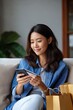 © Iryna - Young asian female shopping online with smartphone and credit card