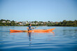 © Serhii - Kayaker paddling on calm lake enjoying water sports and active recreation