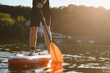 © Serhii - Sportsman paddling on sup board at sunset on lake