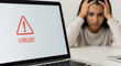 © Kaluya Stock - Stressed woman reacting to a 'VIRUS!' alert on her laptop screen, highlighting digital security risks and computer problems