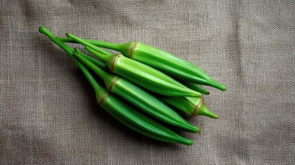 Poster - Fresh okra pods in an overhead layout on burlap fabric with natural light and ample space