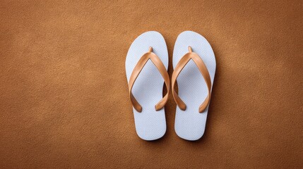 Poster - Minimalist display of white rubber flip flops on sand-textured background with clean copy space