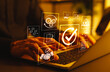© Supatman - Business Quality Assurance and Compliance Concept. Person using laptop with icons represent quality assurance, compliance, process improvement, certification, success, effective operational standards,