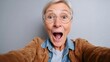 © Echt&KIreativ - Surprised senior woman taking a selfie with open mouth and exaggerated expression
