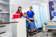 © Westend61 - Two nurses assisting a patient in a wheelchair in a hospital setting