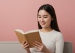 © 9BEi - Young Woman Enjoying a Book on a Pink Background