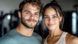 © Yuliia - Young athletic couple smiling at camera in fitness center. Close up portrait of fit man and woman after workout showing healthy lifestyle and wellness.