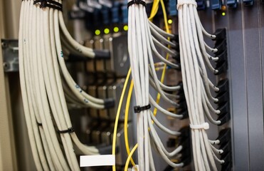 Poster - Flat design showing white and yellow cables bundling in brackets into patch panel with glowing LEDs