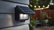 © Stock by Hemal - High-quality photo of this black solar LED wall light combines energy efficiency and sustainability, beautifully lighting up your outdoor space, even in the rain, with a multi-angle.
