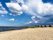© Iulliart - Beautiful calm landscape, seascape, camping, sunny beach, pier, dramatic cloudy blue sky.