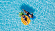 © wedmoments.stock - Happy young couple relaxing on inflatable floats in an outdoor pool, enjoying vacation, drone view. Concept love, summer joy, leisure, freedom and tropical mood.