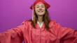 © Krakenimages.com - Young woman in graduation attire smiling confidently against a vibrant pink background, embodying a sense of achievement and joy.