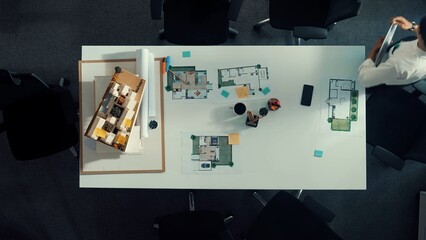 Poster - Top view of architect engineer working together and preparing blueprint and building design for meeting. Time lapse of manager walking at meeting table with model while working together. Alimentation.