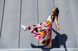 © ADDICTIVE STOCK - Woman in colorful outfit against urban architecture