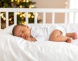 © akun - Baby sleeping peacefully in white crib