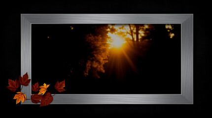 Poster - A rustic wooden frame with autumn leaves captures a golden sunset in a dark forest scene