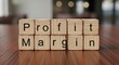 © Habiba - Wooden blocks spelling out profit margin arranged on a wooden surface, symbolizing financial growth