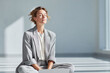 © SolaruS - Calm businesswoman meditating in bright space, eyes closed, seeking inner peace. Serene scene represents mindfulness, focus, and worklife balance.