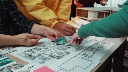 Poster - A lively team meeting showcasing individuals collaborating over design plans and sketches in a modern workspace, promoting creativity and innovative thinking. SACTR