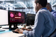 © DC Studio - Group of engineering team coworkers in server hub working to protect equipment from hacker. Men in data center establishment in need of help from technicians to fix security breach alert