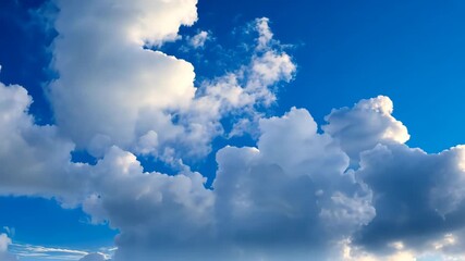 Wall Mural - Cloudscape serenity: A bright blue sky is filled with fluffy, white cumulus clouds, creating a sense of tranquility and vastness