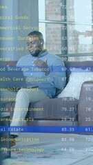 Poster - Animation of financial data processing over afrcian american businessman in office