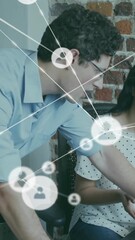 Poster - Animation of network of connections with icons over diverse colleagues using laptop in office