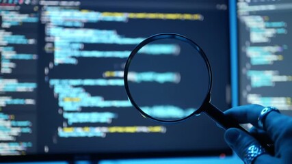 Poster - Hand Holding Magnifying Glass Over Source Code on Computer Screen Illuminating Data Analysis in a Dark Blue Tone