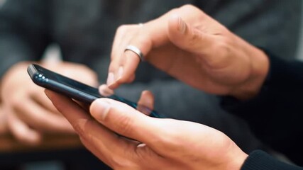 Poster - Hands Using Smartphone with Ring Modern Digital Interface and Blurred Background of Other Person for Adobe Stock Photo