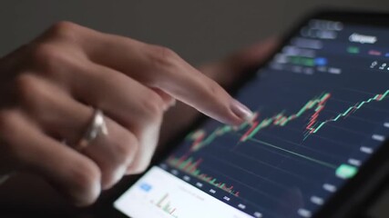 Poster - Woman Analyzing Stock Market Graph on Smartphone Screen with Dark Background and Ring on Finger