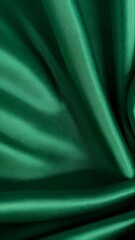 Poster - Elegant emerald green satin fabric with soft wavy folds and a gentle swirl pattern, perfect for luxurious backgrounds and textiles.