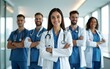 © wang - Group of modern doctors standing as a team with arms crossed in hospital office. Physicians ready to examine and help patients. Medical help, insurance in health care, best desease treatment and