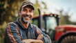 © paukan - Confident farmer standing near his tractor on a farm, looking into the camera