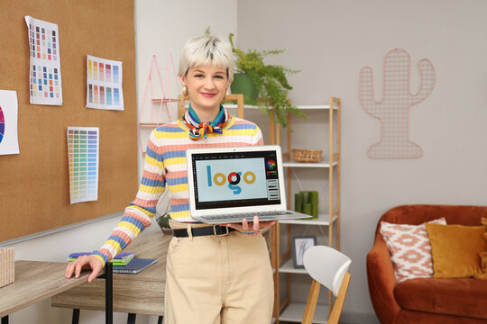 Female graphic designer with laptop in office