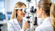 © Giman - Two women in a medical office, one examining the other's eyes using an ophthalmoscope