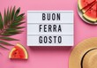 © Laky Begum - Creative flatlay with watermelon pieces straw hat and Buon Ferragosto board on pink summer background