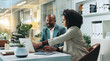 © peopleimages.com - Laptop, business people and team planning in office for insurance, meeting or idea at night. Computer, collaboration and happy African workers with feedback, solution and help with policy on overtime