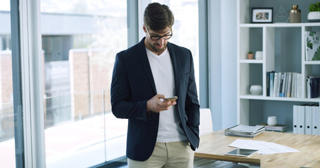 Texting, employee and man with phone, office and communication with contact on social media and web. Reading, message and person with mobile for networking, serious and browsing on app or online