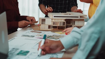 Poster - A group of architects collaborates in a modern office, discussing architectural models and blueprints. The atmosphere encourages innovative ideas and teamwork. SACTR