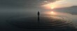 © Jiraporn - Full presence through mental reset concept. A solitary figure stands in tranquil water at sunrise.