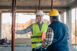 © Ljustina - Engineers discussing building progress at construction site